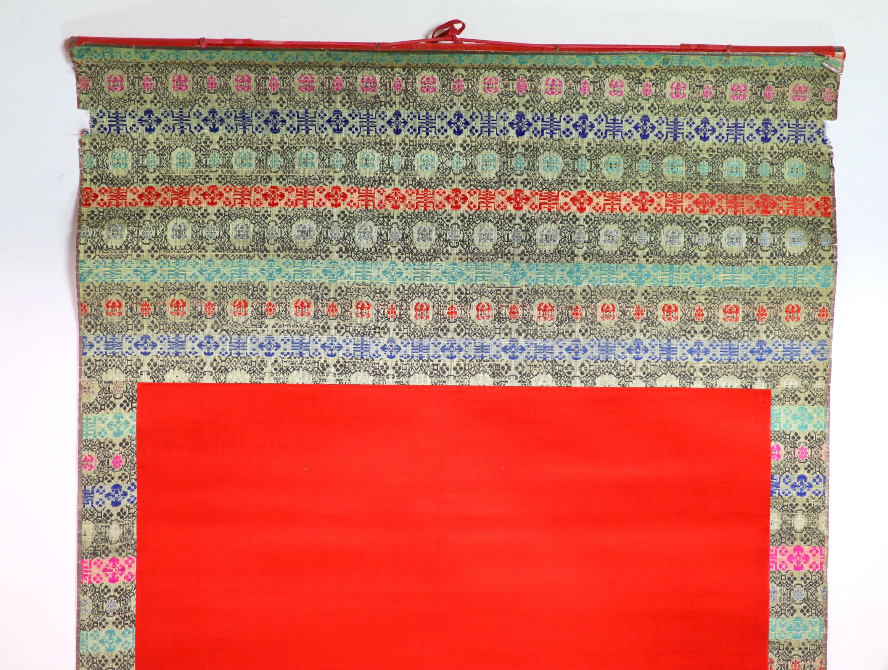 A Chinese embroidered silk ‘peacock’ scroll, late 19th century, 194 x 45 cm excluding brocade borders
